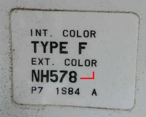 Honda factory paint code label in the driver-side door jamb