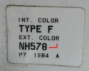 Honda factory paint code label in the driver-side door jamb