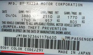 Mazda factory paint code label in the driver-side door jamb