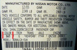 Nissan and Infiniti factory paint code label in the driver-side door jamb
