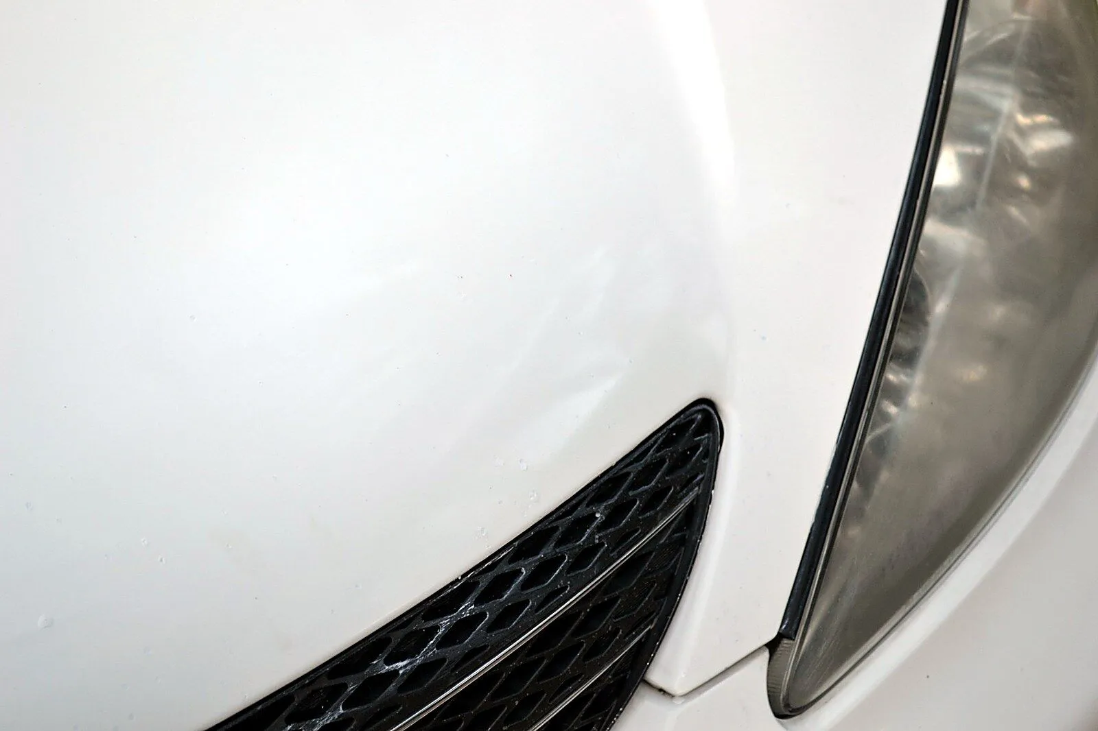 Before and after comparison of white Toyota hood repaired with Dr. ColorChip automotive paint chip repair kit, showing rock chips virtually eliminated.